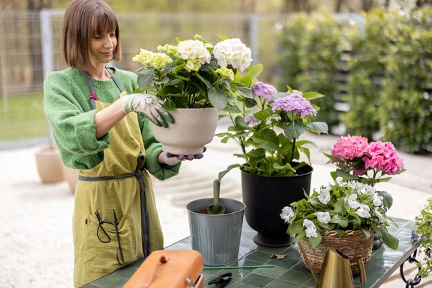 Young woman taking care of flowers in the garden