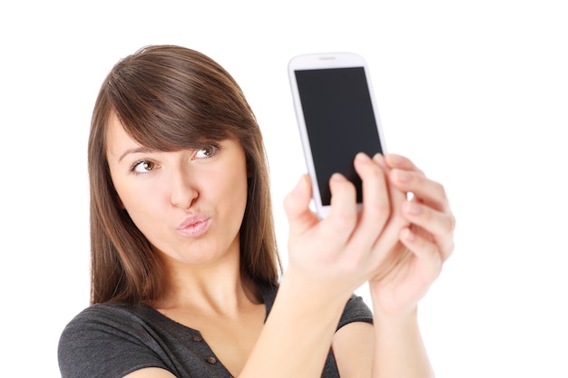 a young woman taking a photo with her smartphone