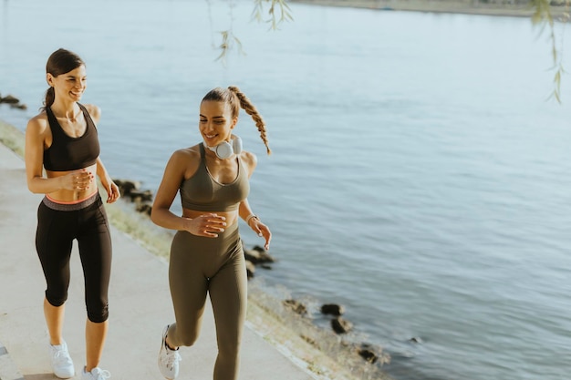 Young woman taking running exercise by the river promenade