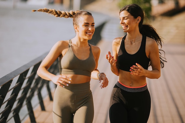 Young woman taking running exercise by the river promenade