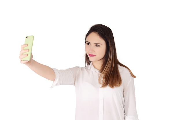 Young woman taking selfie with smartphone