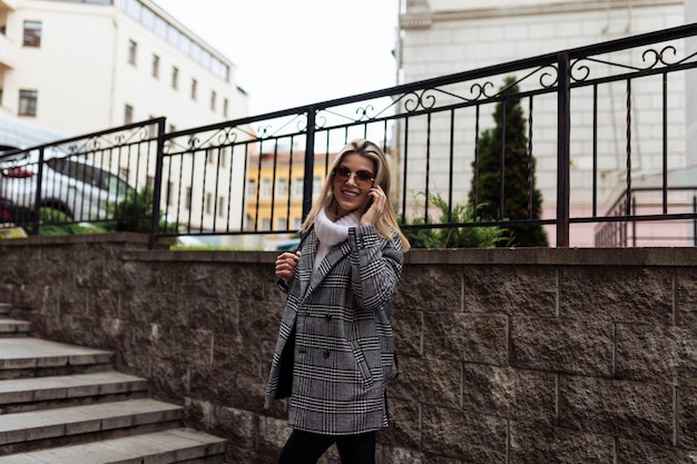 Young woman talking on mobile phone outside on stairs