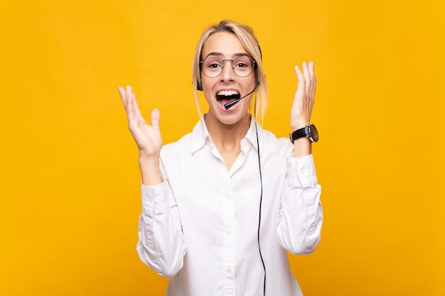 Young woman telemarketer feeling happy, excited