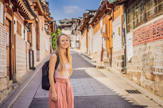 Young woman tourist in Bukchon Hanok Village is one of the famous place for Korean traditional houses have been preserved Travel to Korea Concept