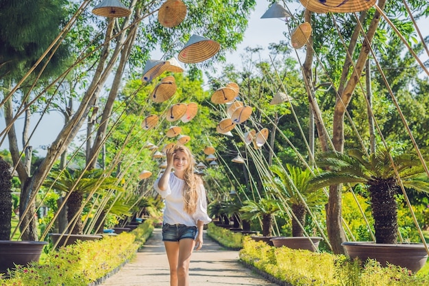 Young woman tourist and vietnamese hats travel around vietnam concept