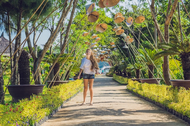 Young woman tourist and Vietnamese hats