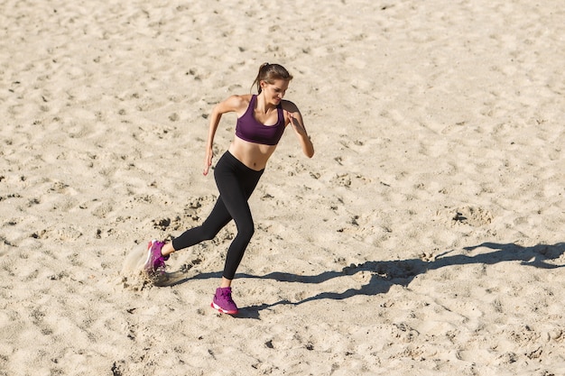 Young woman training outdoors in autumn sunshine.