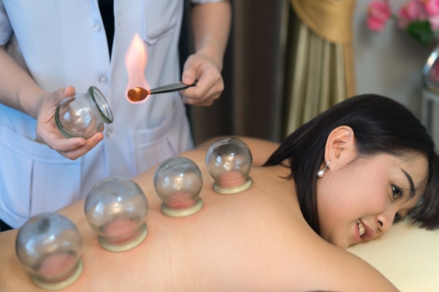 young woman undergoing acupuncture treatment at the health spa