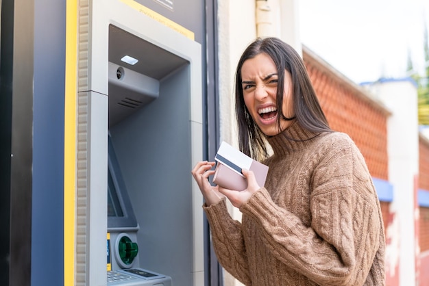 Young woman using an ATM