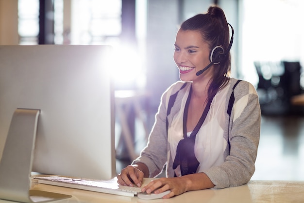 Young woman using computer while working in office