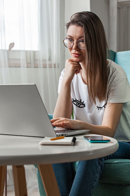 Young woman using laptop to work home