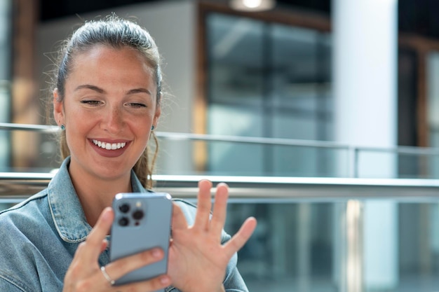 Young woman using mobile phone in a modern office stock photo