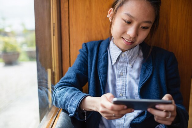 Young woman using mobile phone in office