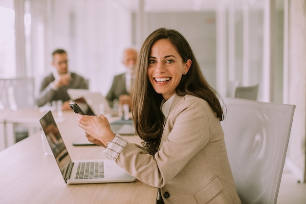 Young woman using mobile phone in the office