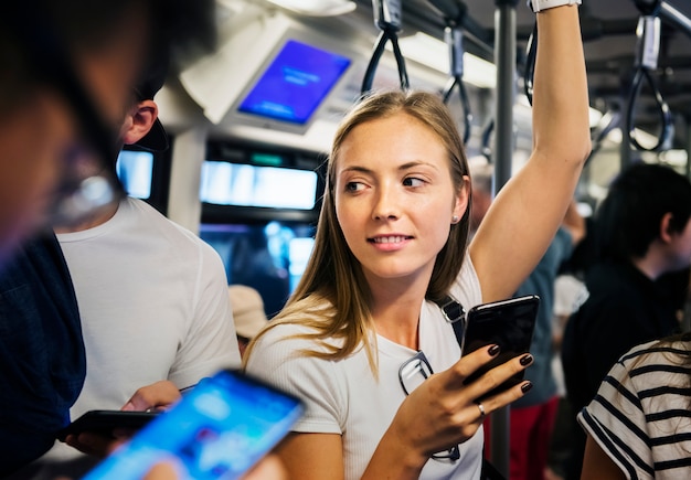 Young woman using a smartphone in the subway