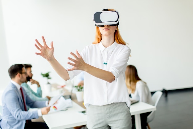 Young woman using virtual reality simulator in the office