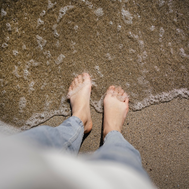 Young woman walking on the beach sand