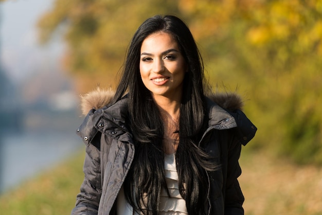 Young Woman Walking In Forest Through The Woods Outside During Autumn