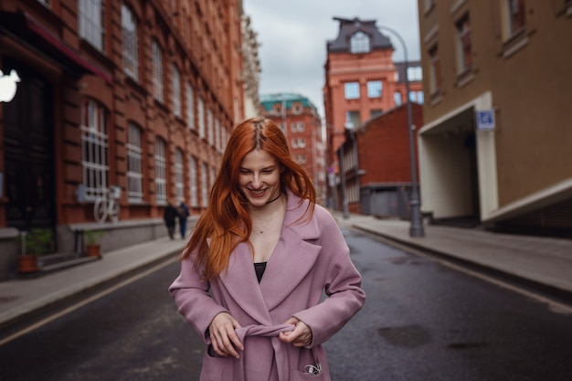 Young woman walking through Moscow streets. Walking on promenade. Gorky Park in early spring or autumn