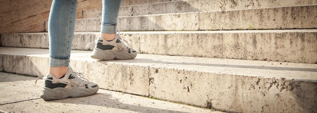 Young woman walking up the stairs in city