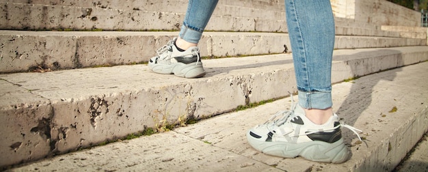 Young woman walking up the stairs in city