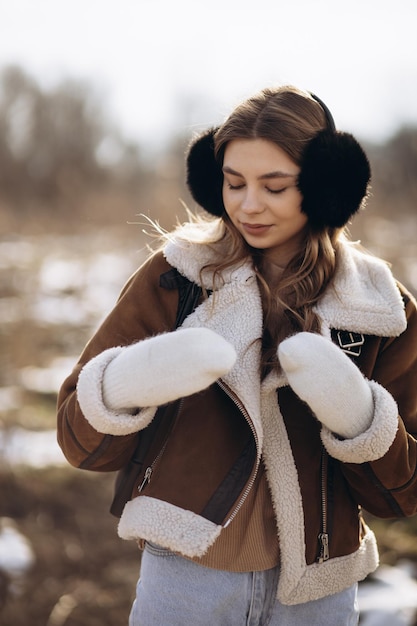 Young woman walking in winter park