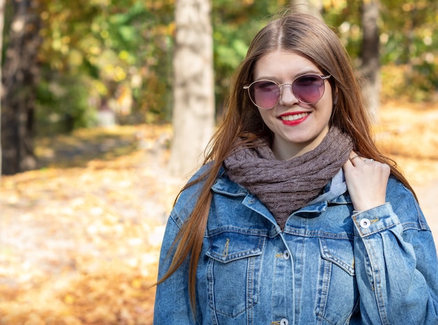 Young woman walks in the park