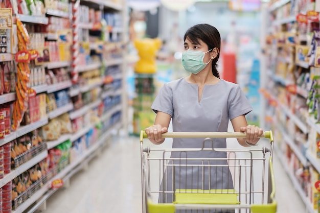 Young woman wearing protective face mask and shopping