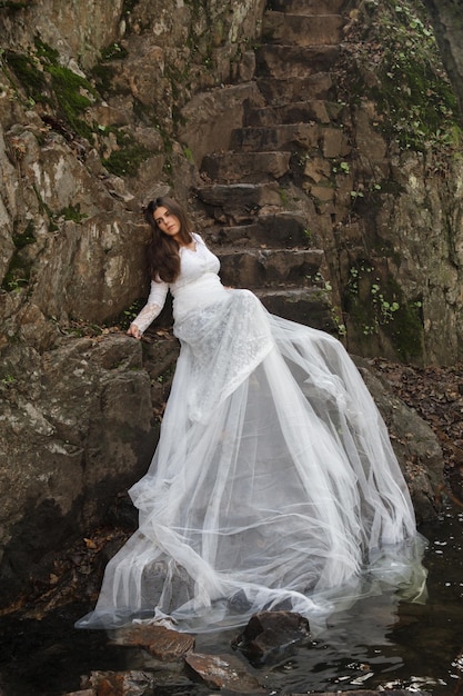 Young woman in wedding dress in the forest