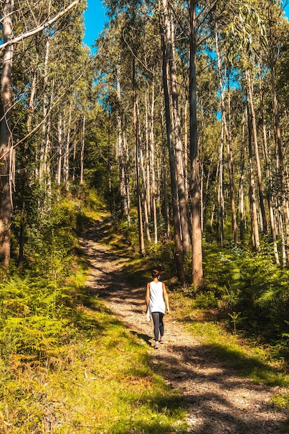 A young woman in a white Tshirt happily strolling in the Listorreta Natural Park