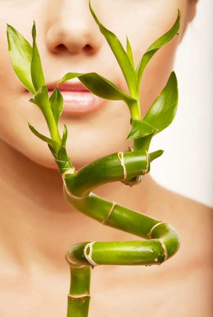 Young woman with bamboo isolated