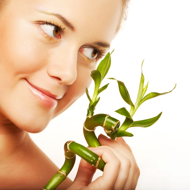 Young woman with bamboo isolated 