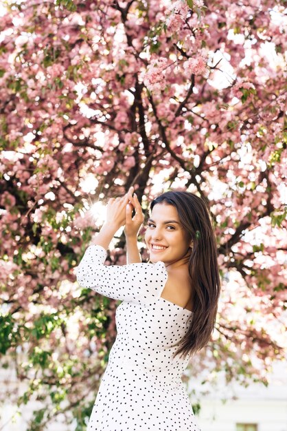 young woman with beautiful brown eyes and long hair with a bright pink lipstick