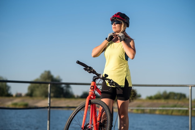 Young woman with bike outdoors at the park