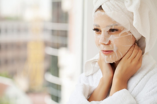 Young woman with cloth mask at spa salon