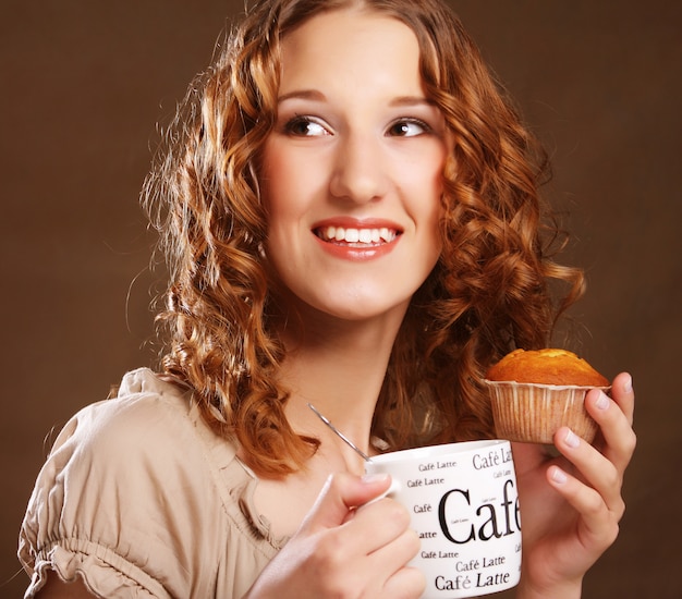 Young woman with coffee and cake