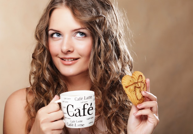 Young woman with coffee and cake