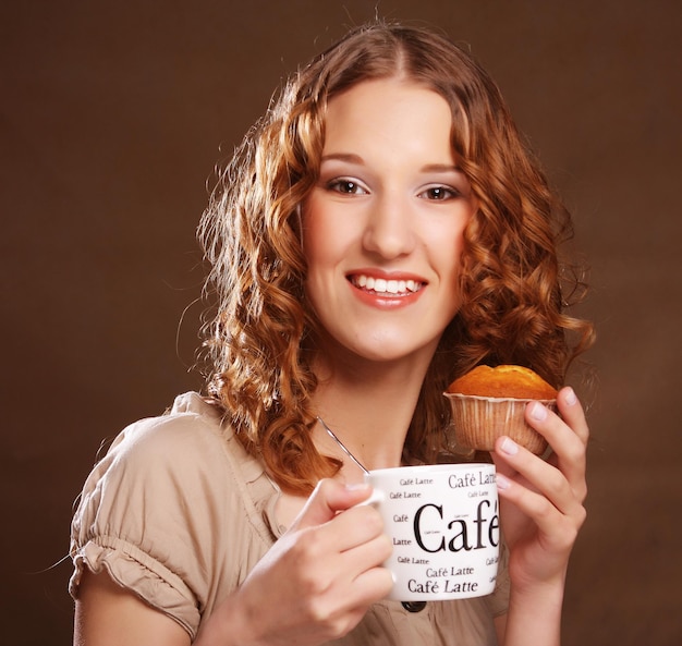 Young woman with coffee and cake