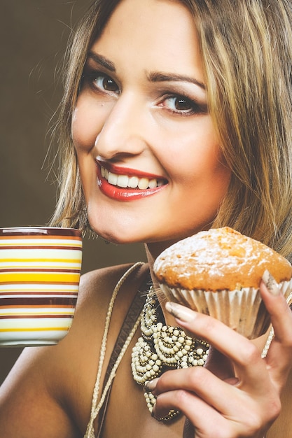 Young woman with coffee and cookies