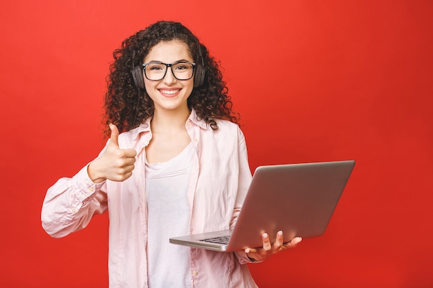 Young woman with curly brunet hair with laptop