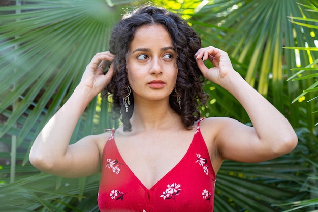 Young woman with curly hair enjoying in a paradise park