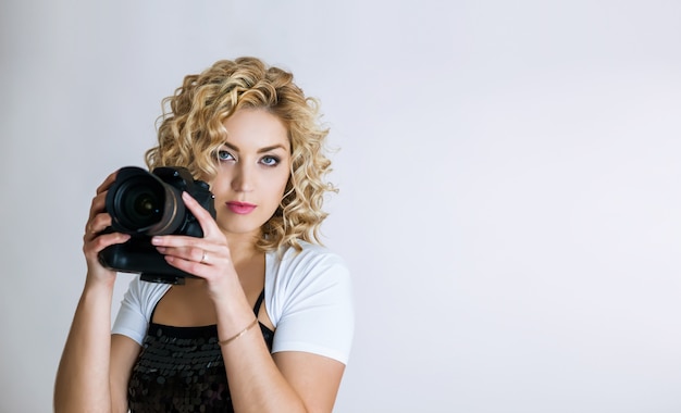 Young woman with digital camera 