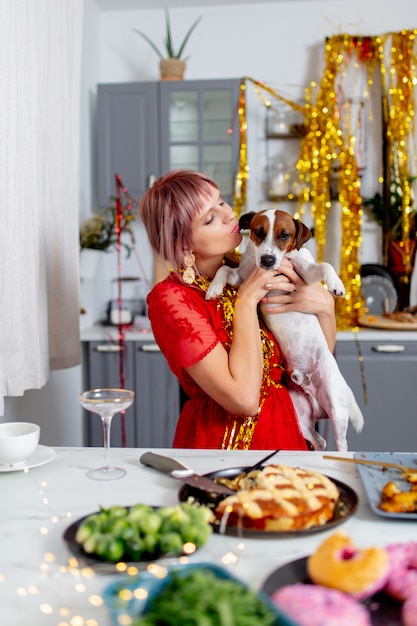 Young woman with a dog sitting in a kitchen after party