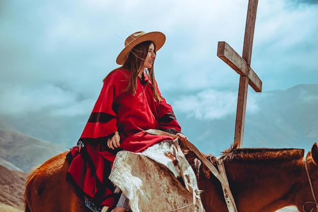 Young woman with gaucho costume riding a horse