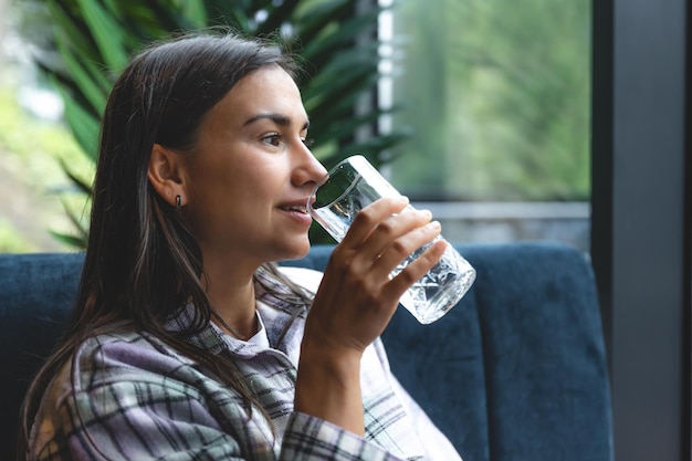 A young woman with a glass of water in a cafe