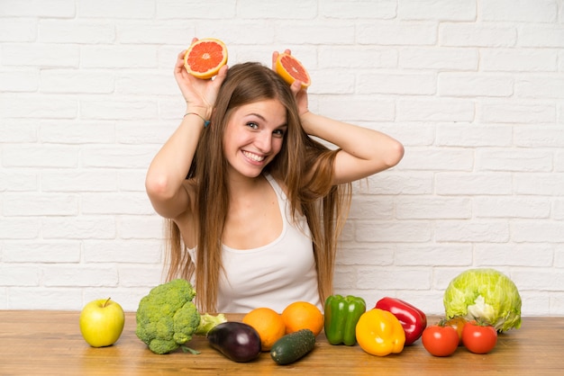 Young woman with a grapefruit ina kitchen