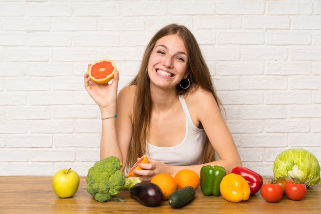 Young woman with a grapefruit ina kitchen