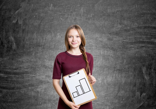 Young woman with graph on clipboard