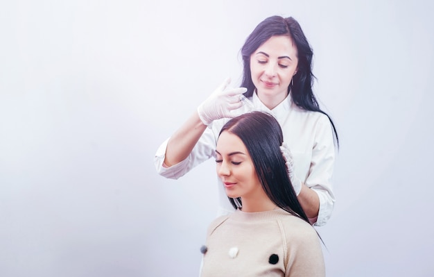 Young woman with hair loss problem receiving injection, close up