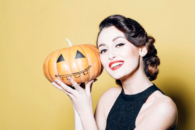 Young woman with Halloween pumpkin